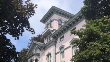 Richardson-Bates House Museum. The focus of the image is the Italianate villa's central tower, as viewed looking upward from ground-level.
