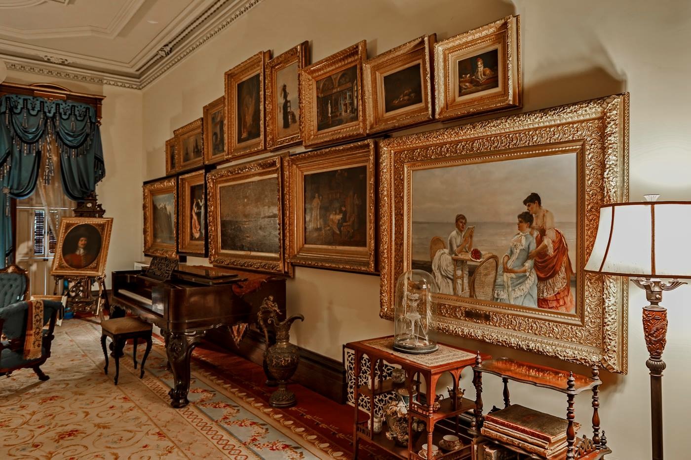 The drawing room piano and paintings wall, as seen from the right.