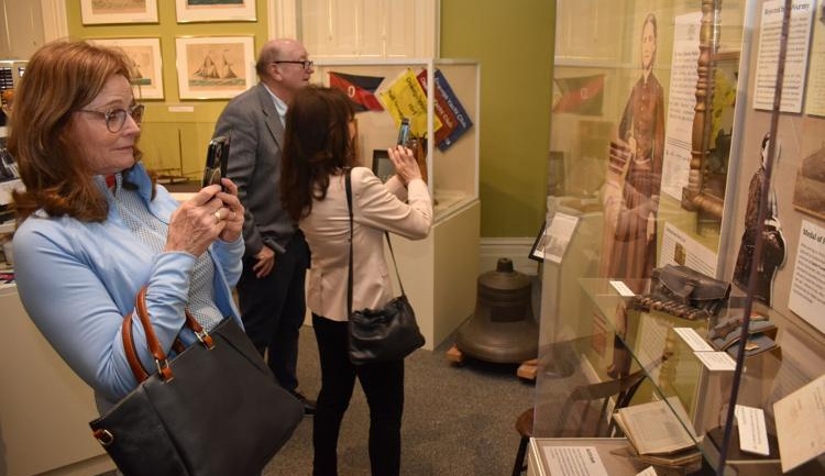 Linda Hall Medaglia takes a photo of Dr. Mary Walker’s Medal of Honor at the Richardson-Bates House Museum in the city of Oswego.