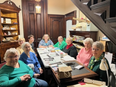 The Auction Planning Committee gathered on March 7 at the Richardson-Bates House Museum. From left to right: Lyn Patterson, Charlene Mitchell, Carol Shannon, Greg Caster, Co-Chair Jennifer Bertollini, Peg McKinstry, Co-Chair Mary Kay Stone, and Mary Shanley. Photo courtesy of Eva Corradino. 