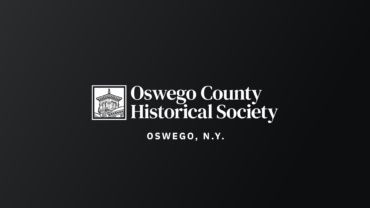 The Oswego County Historical Society logo, in white, on a black gradient background.