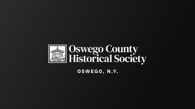 The Oswego County Historical Society logo, in white, on a black gradient background.
